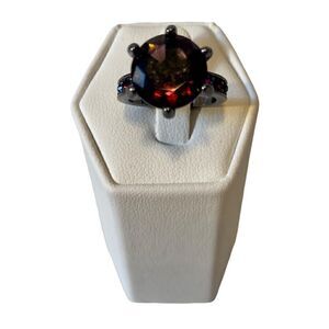 Beautiful Purple Stone Solitaire w/ 3 smaller stones on each side.